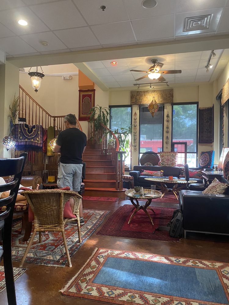 Daytime interior with ornate staircase and comfortable seating