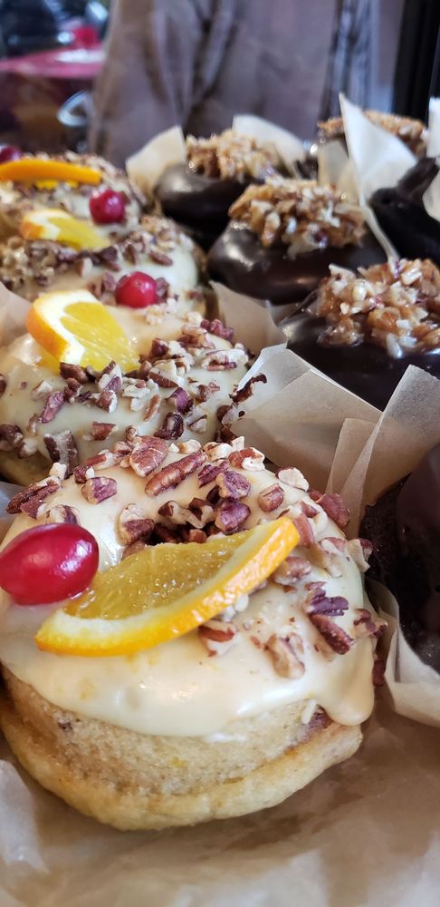 Artisan baked goods with orange and pecan toppings